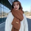 Winter brown knitted scarf for women with handmade label on white sweater - Coffee