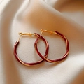 Detail of twisted gold and burgundy enamel hoop earrings on champagne silk fabric - Twisted Hoop Style (12#)