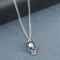 Detailed view of a silver skull pendant necklace with a polished metal finish for men - 55+5cm / Silver