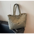 Detail of olive green quilted tote bag with diamond pattern and front snap pocket - Green