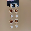 Detalle de pendientes de borla con ojo de tigre, perlas y agujas de plata S925 para mujer - Pendientes Largos De Plata S925 / Marrón dorado