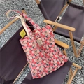 Detailed close-up of pink rose floral print canvas tote bag on an outdoor folding chair - Double Layer Shoulder Style (Double-strap Double-layer)