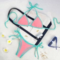 Two-piece pink and teal bikini set with side-tie bottoms on a beach accessory background - Coral Pink/Lake Green