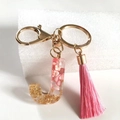 Pink resin letter J keychain with gold foil flakes and matching tassel charm accessory - Letter J