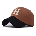 Detail of H letter embroidery on washed cotton baseball cap with contrast black brim - H Patchwork Caramel