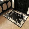 Floral woven polypropylene entry rug with black beige pattern on wooden floor - 50x80cm / Blooming Flowers