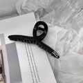 Detail shot of a matte black hair claw clip featuring golden Barrette LaFrance text - Crossed / Cross Style Black