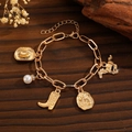 Detailed shot of western cowboy hat and boot charms on a vintage gold pearl bracelet - Gold Western Pearl Bracelet (25 KC Gold 5871)