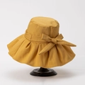 Detail of a ginger yellow sun hat featuring a wide brim, bow accent, and textured cotton fabric - M (56-58cm) / Ginger Yellow