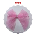Close-up of a pink polka dot organza hair bow with silk ribbon on white card - Pink