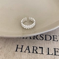 Adjustable hollow floral pattern 925 silver ring displayed on beige ceramic - JZ1143-Hollow Pattern