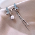 Close-up of asymmetric silver butterfly earrings with blue crystals and long tassels - 19# Blue Asymmetric Butterfly Tassel Earrings