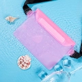 Waterproof purple phone pouch with pink seal and adjustable strap on clear blue water - Pink