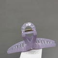 Close-up of large light purple jelly hair claw clip with golden metal spring detail - Purple