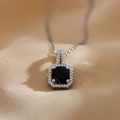 Macro detail of silver square pendant featuring a black gemstone and zircon halo inlay - Silver Black