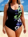 Plus size black one-piece swimsuit with floral print on a sunny beach background - Green Purple Floral