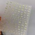 Detailed view of YO-041 gold bowknot nail stickers with metallic reflective texture - YO-041 Gold