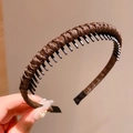 Dark brown braided headband with non-slip teeth for girls hair styling shown in hand - Brown