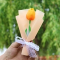 Close-up of a single yellow artificial tulip bouquet with orange paper and white lace bow - Sunset Tulip Champagne Korean Style