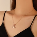Cartoon frog pendant necklace with pink crystals and rose gold plating on a female model - KC Gold Pink Rhinestone WG-1037