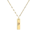 Macro shot of gold-plated rectangular pendant with colorful gemstone letter P engraving - Letter P