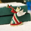 Christmas angel brooch with colorful rhinestones on a gold base over white snow - Christmas Angel