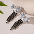 Detailed macro view of butterfly zirconia earrings with long black rhinestone tassels - Silver Needle Silver Black Butterfly Fringe Stud Earrings