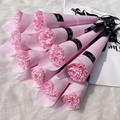 Detailed top view of pink carnation soap bouquets wrapped in paper with black ribbons - Carnation / Pink