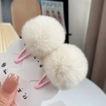 Close-up of soft white faux fur pompom hair clips on a pink metal BB clip base - One Pair / Milky Apricot