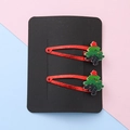 Pair of red glitter Christmas tree hair clips with green resin on a black card - Christmas Tree