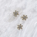 Golden snowflake nail art charm with sparkling AB crystals on a glittery manicure nail - Style A1143-14