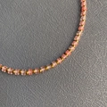 Pink cube resin beads and gold metal beads on a handcrafted layered necklace - Size 9