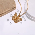 Golden butterfly necklace with rhinestone wings on a stylish rock background - Butterfly