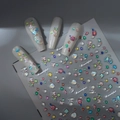 Colorful diamond nail stickers with 3D heart and bow designs on pearly white nails - 3D Colorful Rhinestone Bow Style (CO-408)