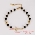 Detail of beaded bracelet featuring a gold cross pendant with sparkling rhinestones - Rhinestone Cross Pendant Style
