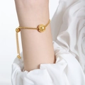 Gold box chain bracelet featuring a central sphere bead and adjustable sliding clasp - 24cm / Gold Bracelet