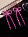 Elegant long tassel earrings with pink rhinestone bows and sparkling finish - Stud Earrings / Rose Red