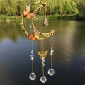 Handmade moon wind chime with blue natural stone and crystal balls hanging outdoors - Lapis Lazuli