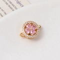 Macro detail of a gold rotating flower clasp with pink zircon heart petals and pavé crystals - 15# 14K Gold Single Row (13*18mm)