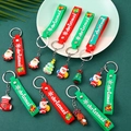 Weihnachts Schlüsselanhänger aus PVC mit Weihnachtsmann Motiven auf grünem Hintergrund - Weihnachtsserie (Mit Gurt)