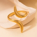 Close-up of a gold snake-shaped ring with a matte finish on a minimalist stone base - Gold 28