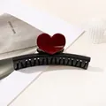 Detail of a large black resin claw clip featuring a 3D red heart on a white background - Heart Straight / Black