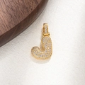 Detailed view of golden letter J pendant featuring pave-set sparkling cubic zirconia - Letter J
