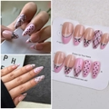 Detail of almond press-on nails with pink base, black bows, and rhinestones - Wy-044 / 10 Pieces In Xs Size