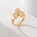 Elegant gold clover leaf open ring with zircon inlay on a white geometry background - Clover Design (JZ013)