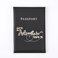 Close-up of black PU leather passport holder with gold foil adventure quote and text - Black