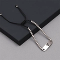 Close-up of medical alert bracelet with stainless steel plate and black braided rope cord - Bead Chain Medical Alert