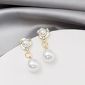 Macro detail of gold double pearl drop earrings with sparkling rhinestone accents - Gold Double Pearl Drop Dangle
