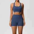 Detail view of double-sided brushed yoga set featuring sports bra and shorts with pockets - Navy Blue