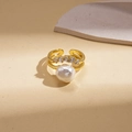 Macro detail of gold-plated double-layer ring with baroque pearl and zircon accents - Gold Double Layer